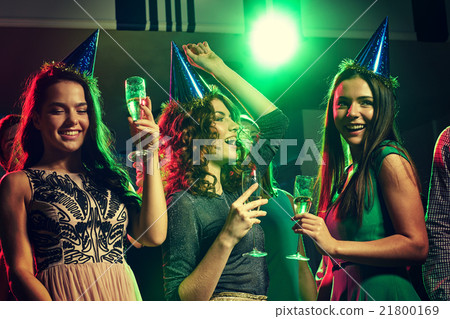 smiling friends with glasses of champagne in club 21800169