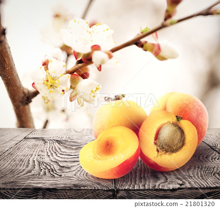 Apricots lie on wooden table 21801320