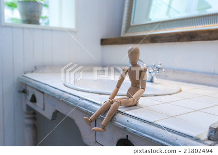 A drawing mannequin sitting on a sink, an image of quiet everyday life. A drawing mannequin sitting on a sink, an image of quiet everyday life. 21802494