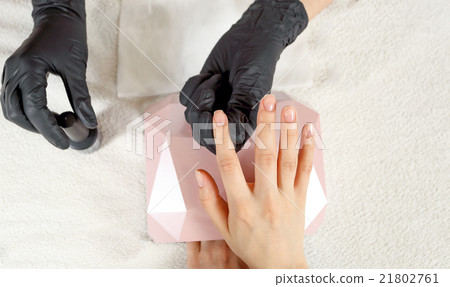 Top view manicurist holds customer hands Top view manicurist holds customer hands 21802761