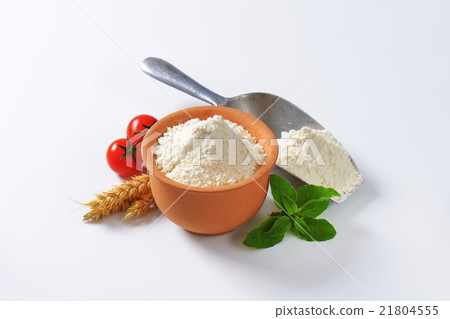 Wheat flour in terracotta dish and metal scoop 21804555