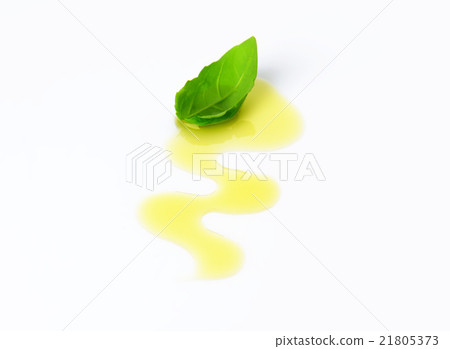 Olive oil drizzle and basil leaf 21805373
