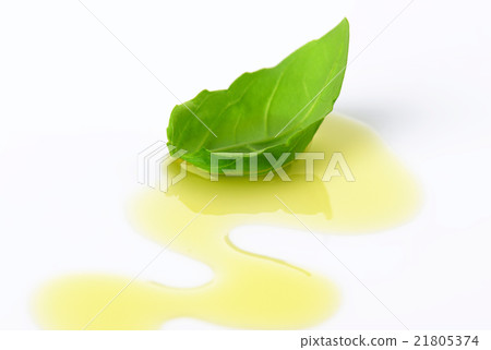 Olive oil drizzle and basil leaf 21805374