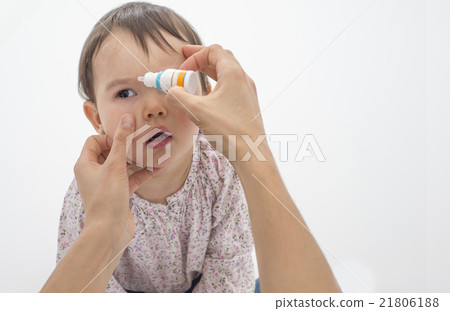 Closeup of mother pouring eye drops in the eye of her daughter Closeup of mother pouring eye drops in the eye of her daughter 21806188