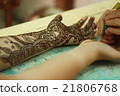 Process of applying Mehndi on female hand.  21806768