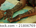 Process of applying Mehndi on female hand.  21806769