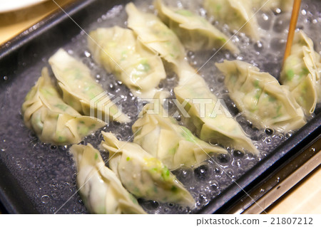 Grilled dumpling on steel plate Grilled dumpling on steel plate 21807212