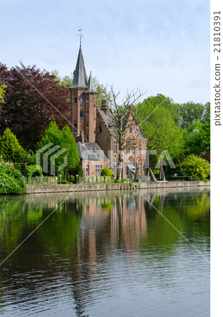 Flemish style castle in Minnewater lake in Bruges 21810391