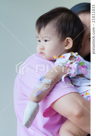 Mother carrying sick baby in hospital 21811835