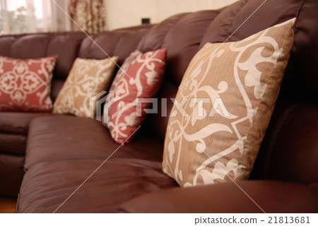 pillows on a leather sofa 21813681