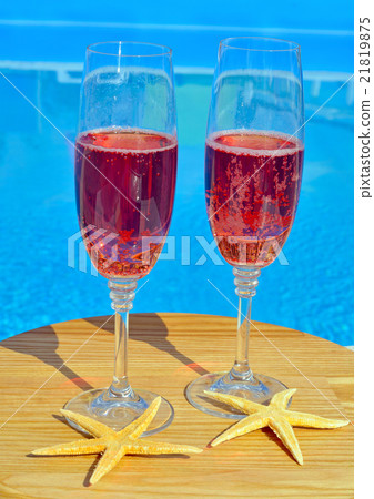Two glasses with red wine on pool background 21819875