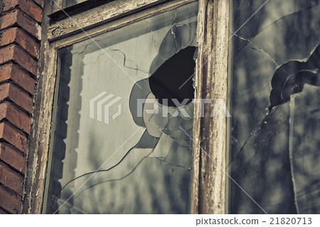 broken glass window reflecting clounding sky 21820713