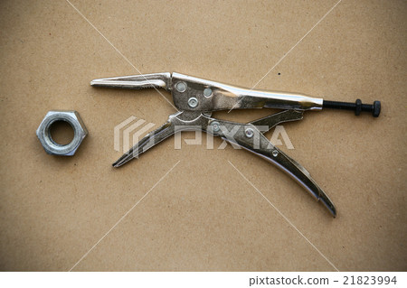 close up locking pliers on wooden background 21823994