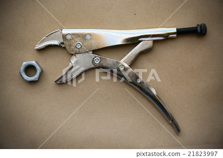 close up locking pliers on wooden background close up locking pliers on wooden background 21823997