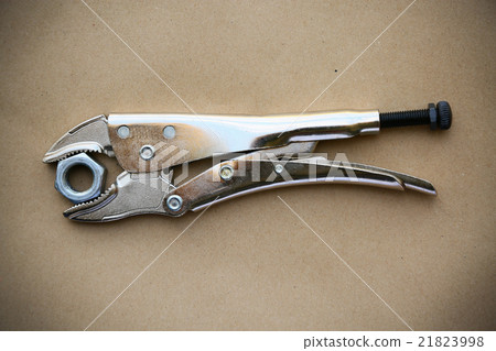 close up locking pliers on wooden background close up locking pliers on wooden background 21823998