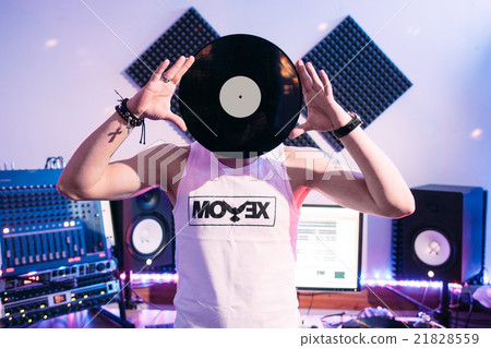 DJ holds vinyl record in recording studio DJ holds vinyl record in recording studio 21828559