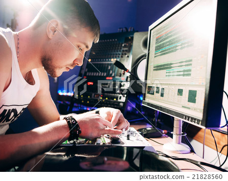 DJ adjusts music equipment before starting work 21828560
