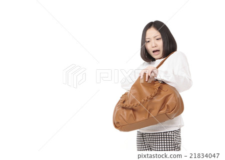 A young woman looking for something left behind 21834047