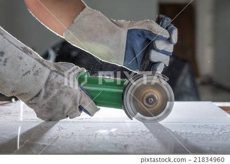 Gloved hand of a construction worker Cutting Gloved hand of a construction worker Cutting 21834960