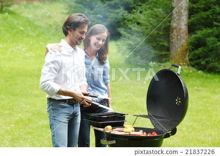 Couple cooking on barbecue Couple cooking on barbecue 21837226