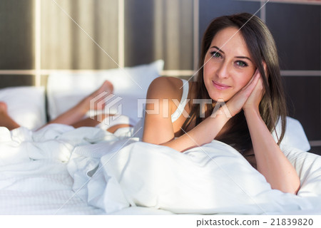 portrait of beautiful woman on bed looking in 21839820