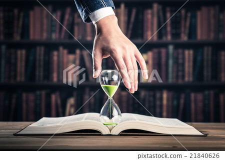 Heavy book and hourglass Heavy book and hourglass 21840626