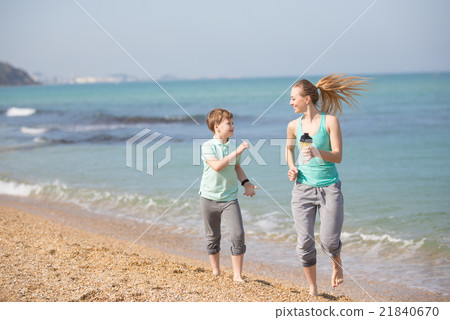 Mother with son running on the beach Mother with son running on the beach 21840670