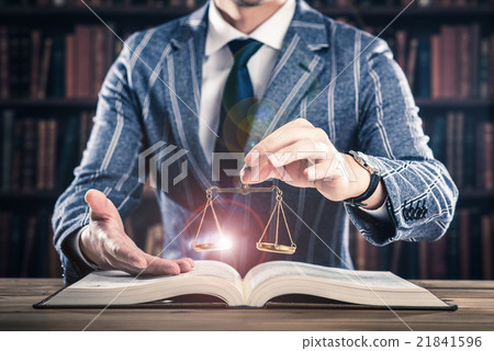 A man holding a balance, a heavy book 21841596