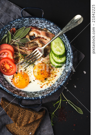 Breakfast set. Pan of fried eggs with bacon, fresh Breakfast set. Pan of fried eggs with bacon, fresh 21842225