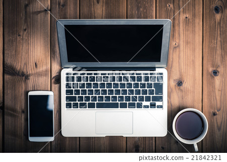 Laptop, laptop computer, wooden table, bird's eye view, coffee cup and smartphone Laptop, laptop computer, wooden table, bird's eye view, coffee cup and smartphone 21842321