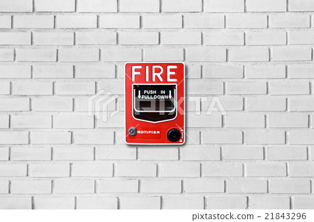 Fire alarm switch on white brick wall background Fire alarm switch on white brick wall background 21843296