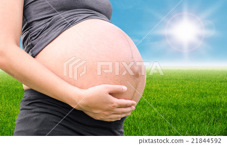 Pragnant woman in meadow with blue sky Pragnant woman in meadow with blue sky 21844592