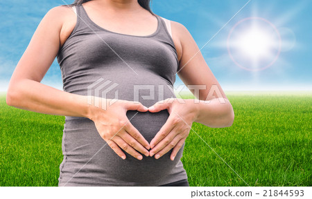 Pregnant Asian woman put her hands on belly Pregnant Asian woman put her hands on belly 21844593