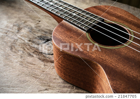 Close up of ukulele on old wooden background Close up of ukulele on old wooden background 21847705