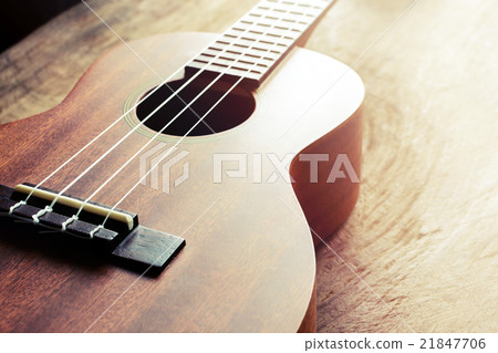 Close up of ukulele on old wood background 21847706
