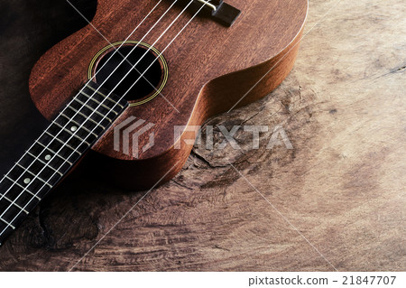 Close up of ukulele on old wood background Close up of ukulele on old wood background 21847707