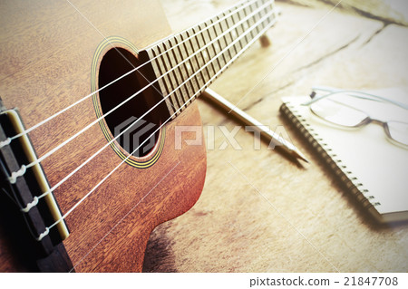 Close up of ukulele on old wood background Close up of ukulele on old wood background 21847708