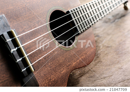 Close up of ukulele on old wood background Close up of ukulele on old wood background 21847709
