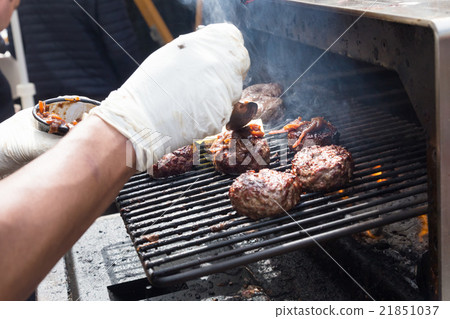 Beef burgers being grilled on food stall grill. Beef burgers being grilled on food stall grill. 21851037