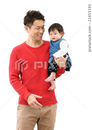 A young dad holding a baby A young dad holding a baby 21853193