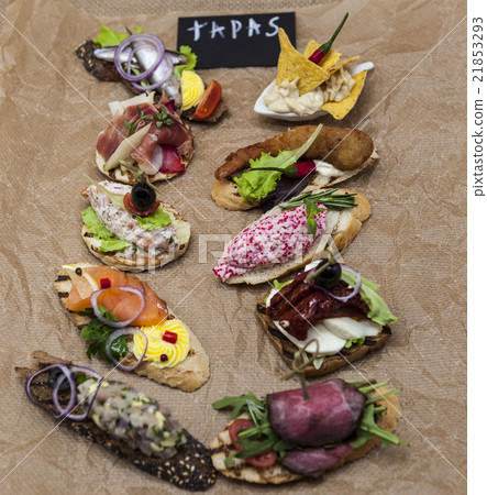 Set of Spanish tapas on the textiles background Set of Spanish tapas on the textiles background 21853293