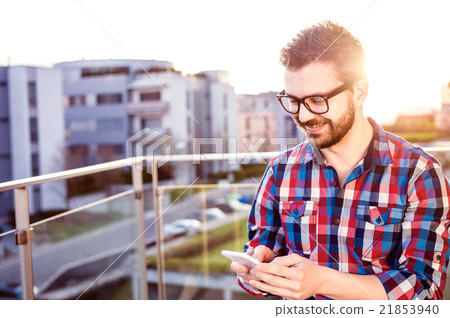 Hipster businessman with smart phone texting 21853940