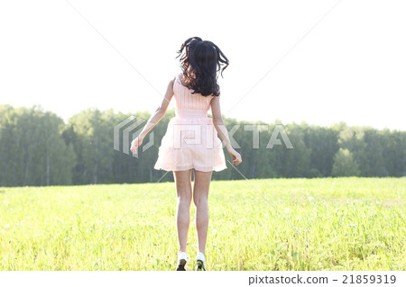 The girl pink dress is jumping meadow summer The girl pink dress is jumping meadow summer 21859319