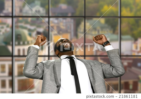 Afro businessman expressing joy. Afro businessman expressing joy. 21861181