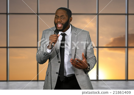 Black singer holding microphone. 21861409