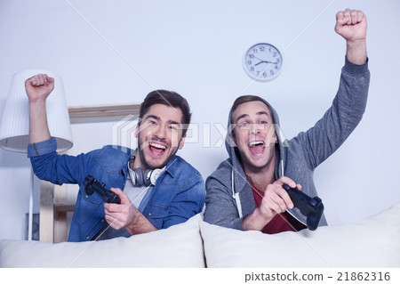 Skillful male players are competing in video game Skillful male players are competing in video game 21862316