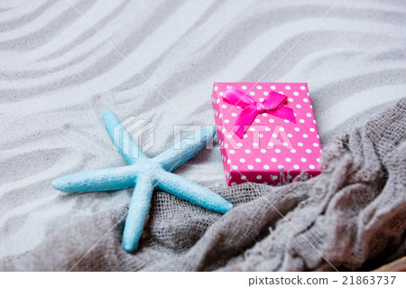 starfish, gift and fishnet on the sand starfish, gift and fishnet on the sand 21863737