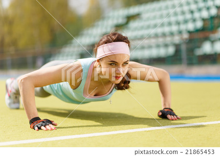 Young sporty woman doing push up exercise outdoors Young sporty woman doing push up exercise outdoors 21865453
