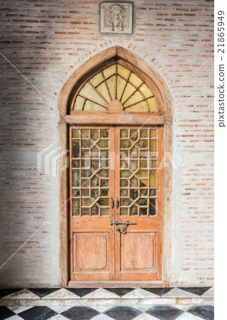 The wooden front door of a home with glass 21865949