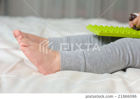 Legs of child sitting on the bed Legs of child sitting on the bed 21866096
